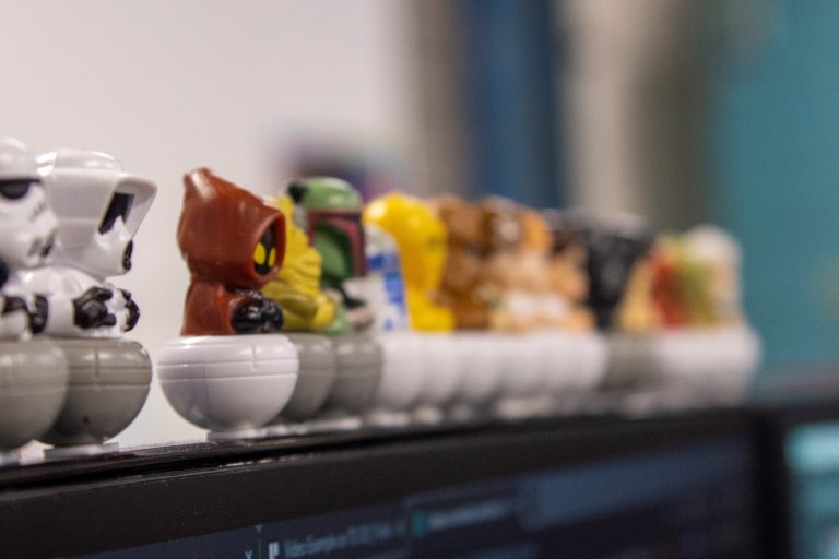 plastic toys balanced on the top of a computer screen 