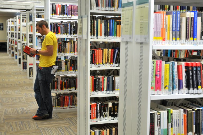 Man browsing library shelves