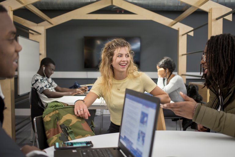 3 students working in the library